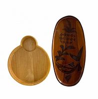 Front view showing round board with integrated section and oval carved board