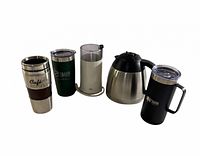 Group of five coffee accessories: Braun grinder, thermal carafe, three insulated travel mugs