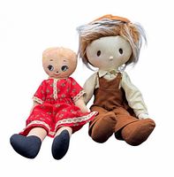 Front view of both cloth dolls sitting upright