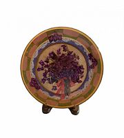 Front of hand-painted ceramic plate on stand