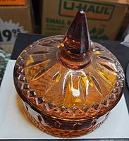 Overall view of amber covered candy dish with lid and finial