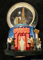 Front view showing Eiffel Tower and Le Paris café façade