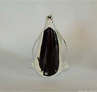 Front view of clear glass penguin showing black sommerso core