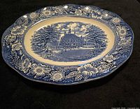 Top view of blue and white Liberty Blue oval platter showing floral border and Governor's House scene