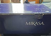 Exterior of original Mikasa box showing logo and taped damage
