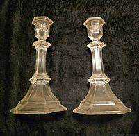 Front view of both clear glass candlestick holders showing full shape