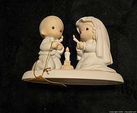 Front view of figurine showing bride, groom and unity candle