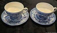 Two teacup and saucer sets displayed top view