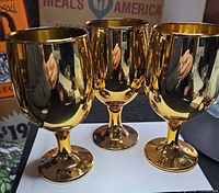 Three gold-electroplated goblets showing exterior finish and shape