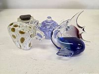 Four hand-blown glass items: inkwell, dolphin figurine, spotted paperweight, lavender jar