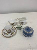 All six porcelain items grouped on tabletop