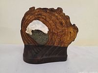 Front view showing wood grain, stone and white accent