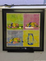 Framed four-panel mixed media artwork under glass