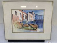 Frontal view of framed watercolour showing complete image, mat and frame