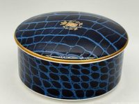 Closed accessory box showing exterior pattern and gold rim