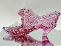 Left side view of pink iridescent glass slipper
