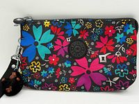 Front view of wristlet showing floral pattern and logo