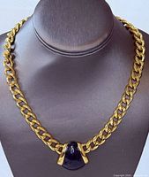 Full view of Monet gold-tone chain choker with black enamel pendant displayed on bust