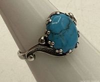 Top view of sterling silver ring showing oval turquoise stone and prong setting