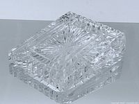 Oblique view of Waterford rectangular crystal paperweight showing starburst pattern and faceted edges