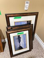 Three stacked brown wood-framed landscape photos