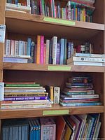 Four bookshelf shelves filled with assorted children's books; some titles discernible