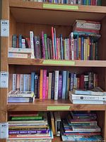 Full bookshelf showing three shelves of assorted books