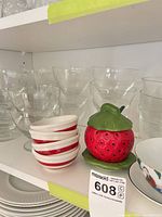 Stacked clear glass dessert bowls, striped ceramic dipping bowls, strawberry shaker
