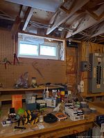 Workbench with clamps, adhesives, WD-40, paint pots and hardware
