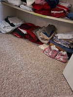 Shelved stacks of assorted linens in various colors and patterns
