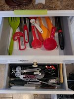 Overview of two open drawers showing majority of utensils