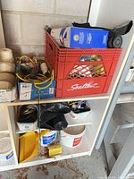 Overview of lot on shelving with twine, ropes, tape, plastic sheeting, buckets, crate