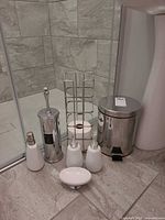 Full set arranged: two dispensers, soap dish, toilet brush holder, trash can, toilet paper rack