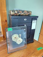 Jewelry armoire with floral tin on top and pressed-flower glass frame in front