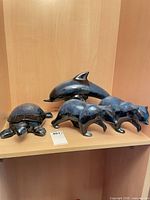 Shelf with dolphin, turtle and two bear figurines