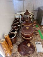 Full lot showing teapot, mugs, serving pots, lids, vases