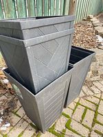 Four nested slate gray slatted plastic planters