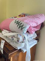 Stack showing quilt, receiving blankets and teddy bear on furniture