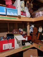 shelf with ornament boxes, sleigh, garland, batting