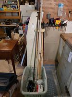 Overall lot showing ironing board, basket with rod, iron, masks