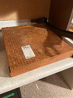Top view of Ingento paper cutter showing full wood base grid and partial blade arm