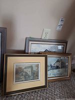 Three framed Keirstead prints leaning against wall