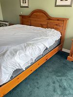 King panel bed frame left side view with mattress in place