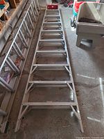 Full view of both aluminum ladder sections laid on floor