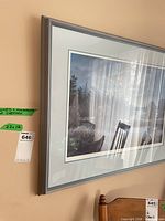 Full view of framed lithograph on wall