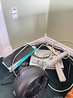 Pile showing keyboard, DVD player, fan, power bar and cables