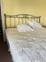 Full view of metal headboard and mattress assembled