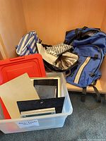 Group shot showing backpacks, bags and bin with frames