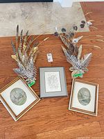 Group shot of all framed artworks and metal sculptures