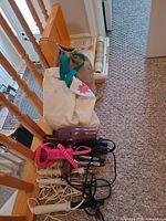 Entire lot showing curling irons, handheld dryers, bags, cords and Brother dryer case